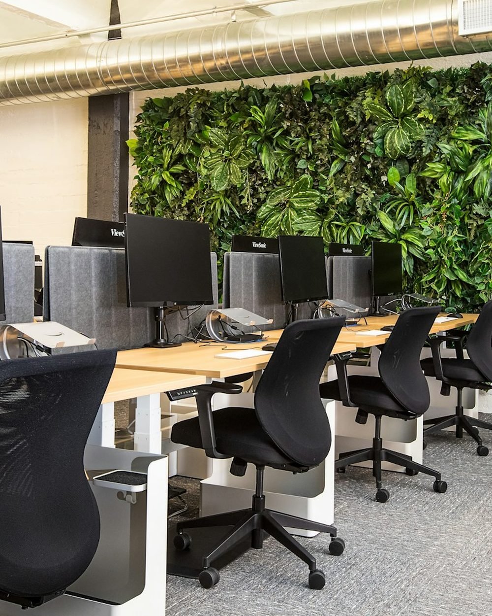 Modern black ergonomic office chairs around a desk — multiple options for different home offices