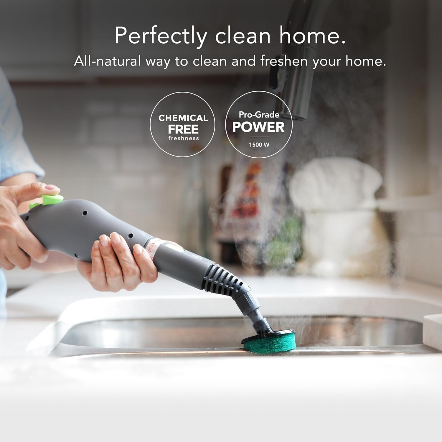 Steamfast SF-370WH handheld steam cleaner scrubbing a kitchen sink with the scrub pad attachment