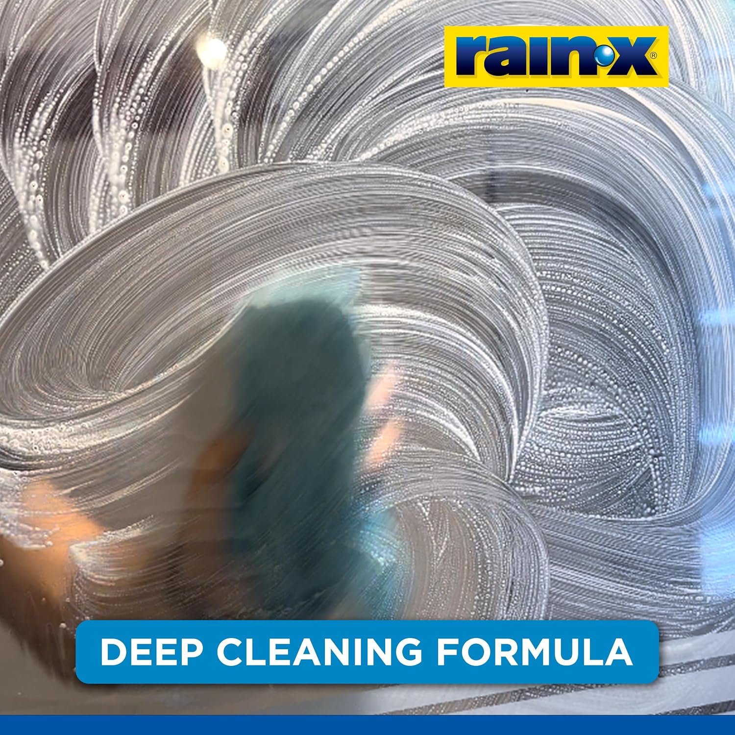 Rain-X promotional image showing a cloth moving cleaner in circles on shower glass